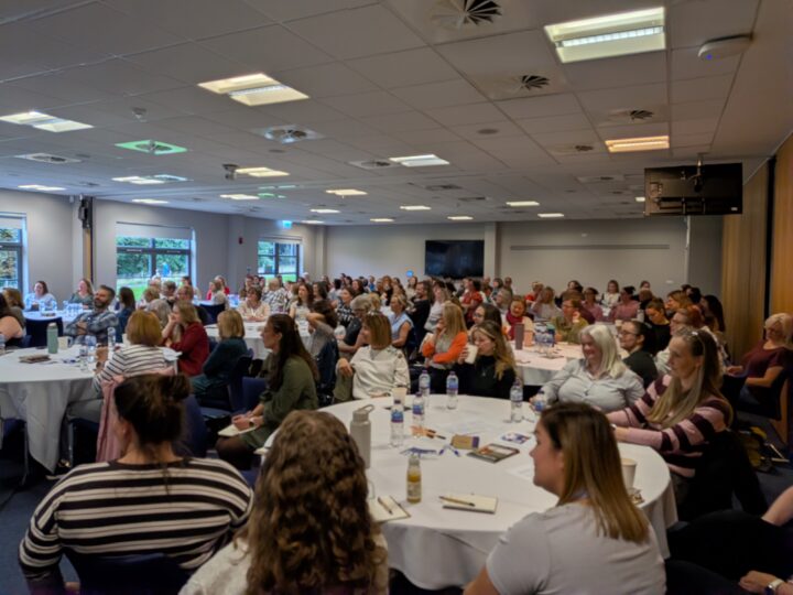Conference Attendees sitting in main room